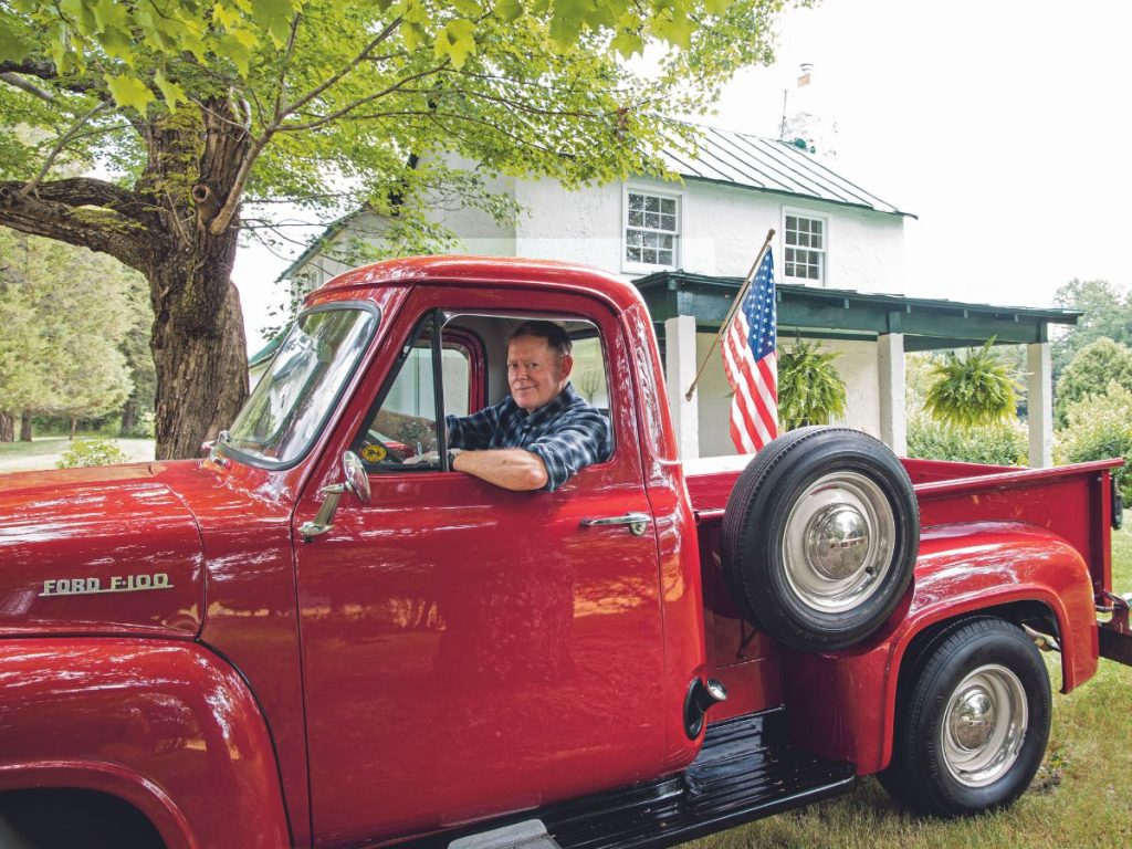 Photo of Red Truck Bakery owner Brian Noyes in his antique, red Ford truck.